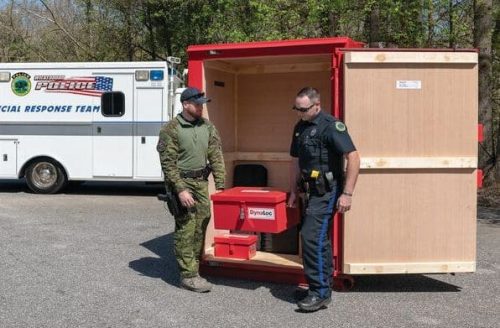 EL510_EL531_EL229_5_app Two officers moving a type 3 day box from within a type 2 explosive magazine from U.S. Chemical Storage